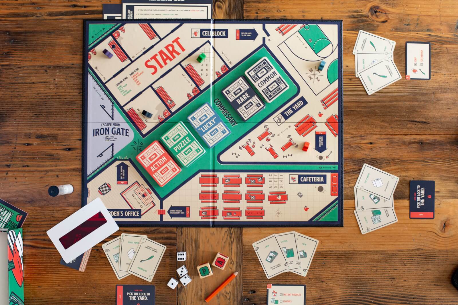 An escape room themed board game sits ready to play on a table. The board is offered online from The Escape Game Atlanta. 